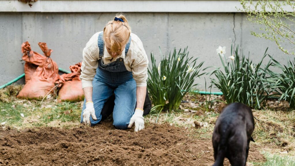 Woman working with soil in garden