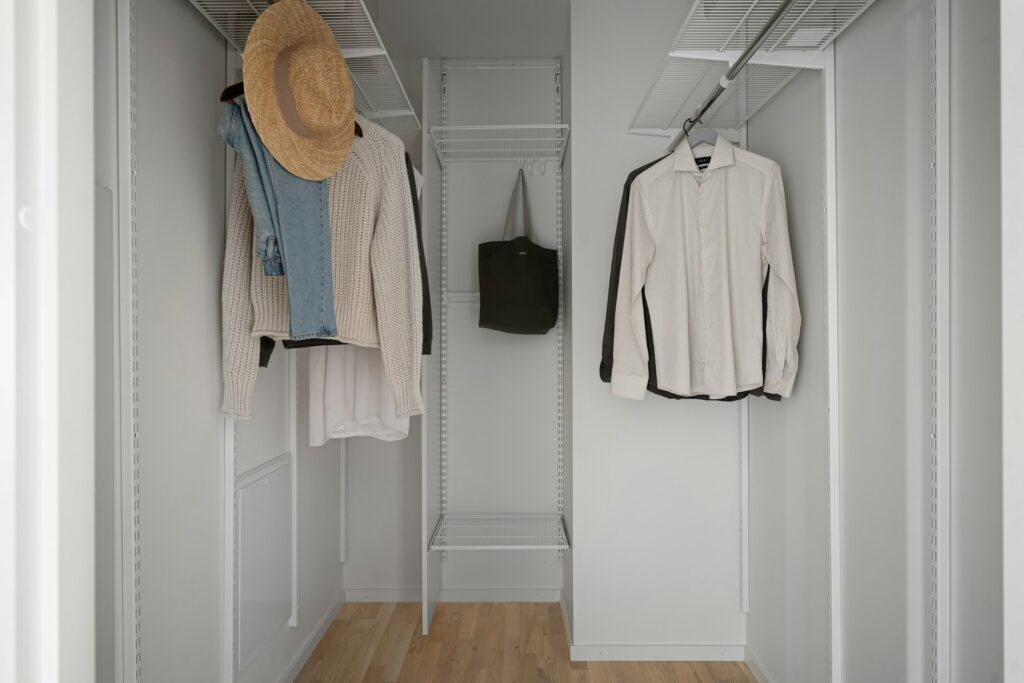 a-white-closet-with-a-hat-and-coat-rack