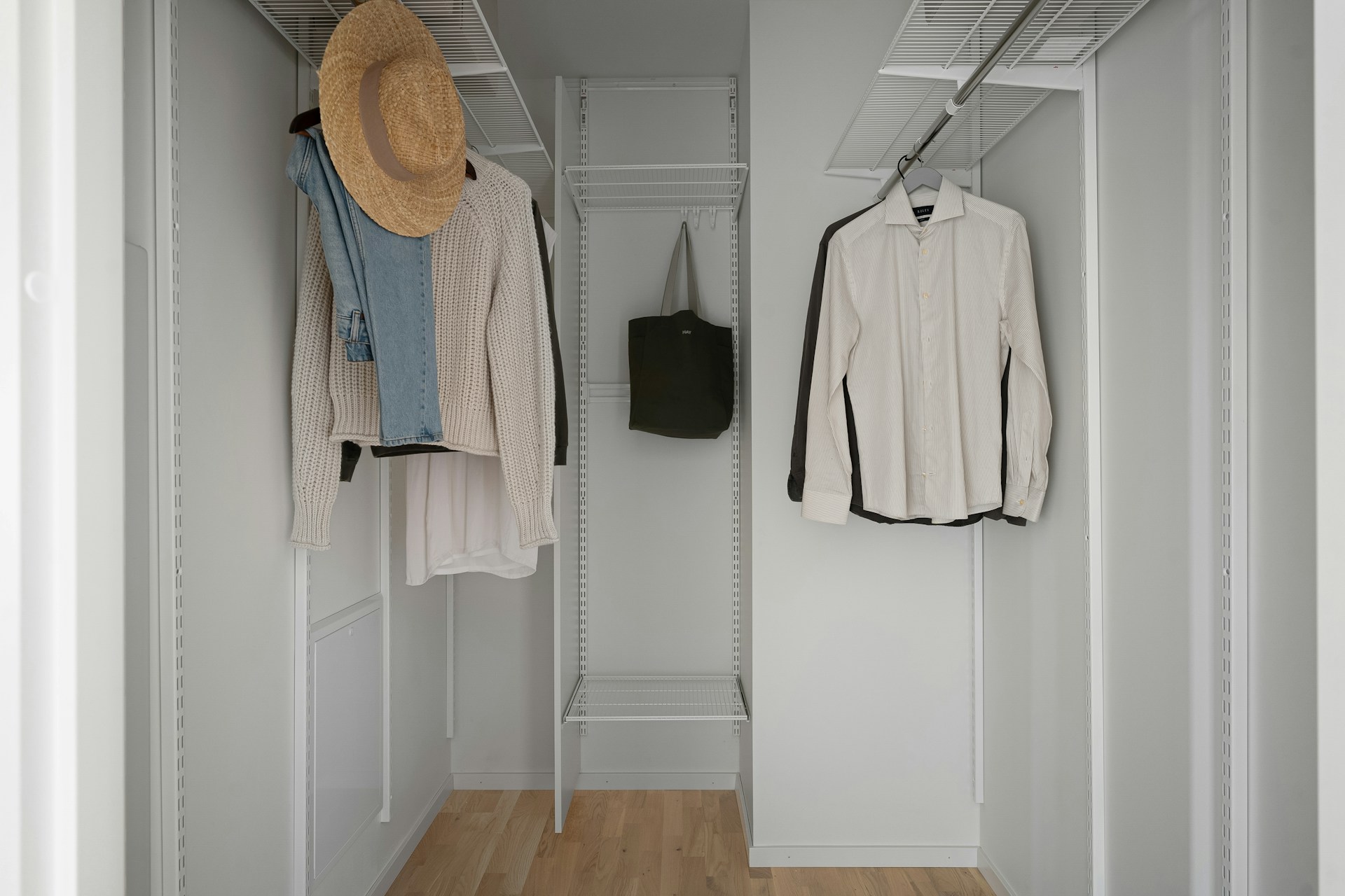 a-white-closet-with-a-hat-and-coat-rack